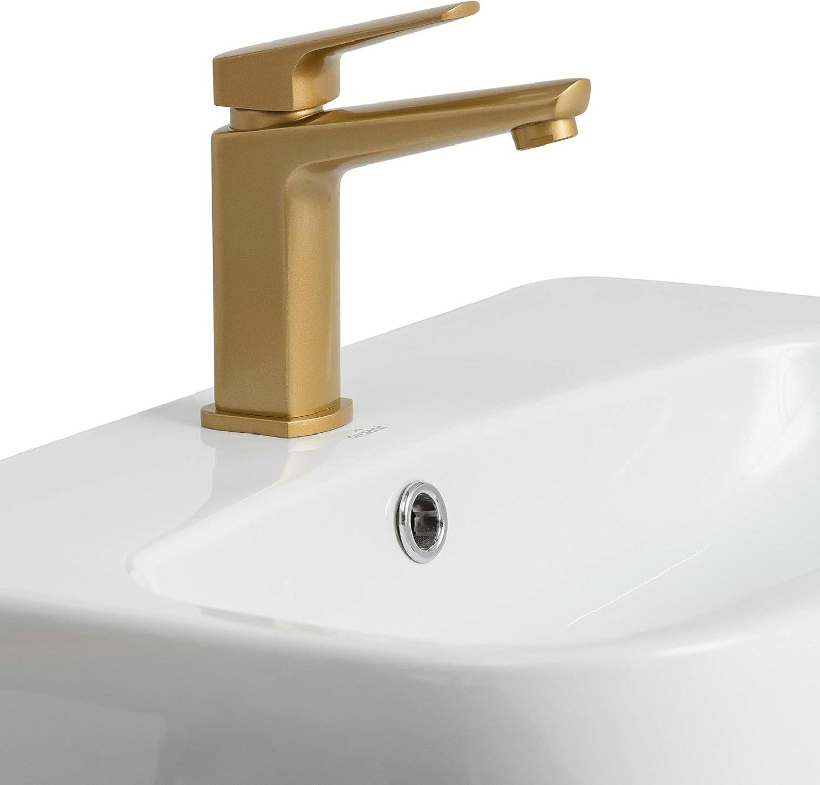 Goldene Waschtischarmatur mit Ablaufgarnitur